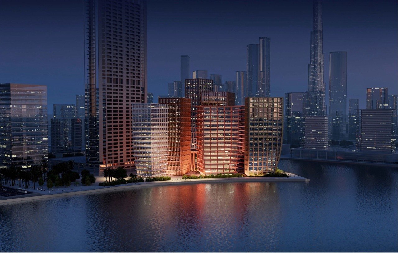 Bureau Lamar — night render of the waterfront development glowing along Business Bay canal, Dubai